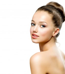 Young Model with Large Hair Bun Looking Over Shoulder Rhinoplasty Dallas