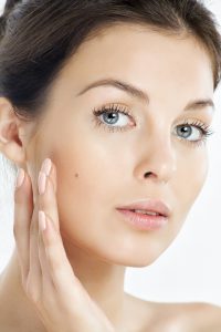 Middle Aged Model Touching Mid Finger to Cheek Facelift Dallas