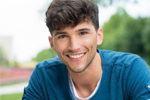 Young Man in Blue Sweater with Slight Facial Hair and Dark Hair